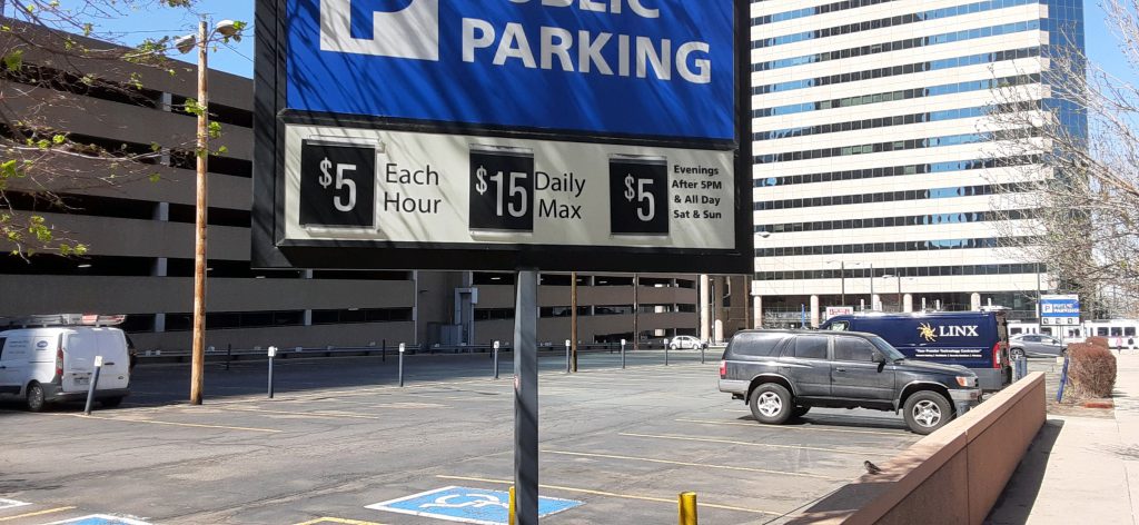 A sign identifying the pricing for parking. $5/hour up to $15.